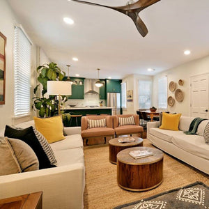 living room with open kitchen with green cabinets