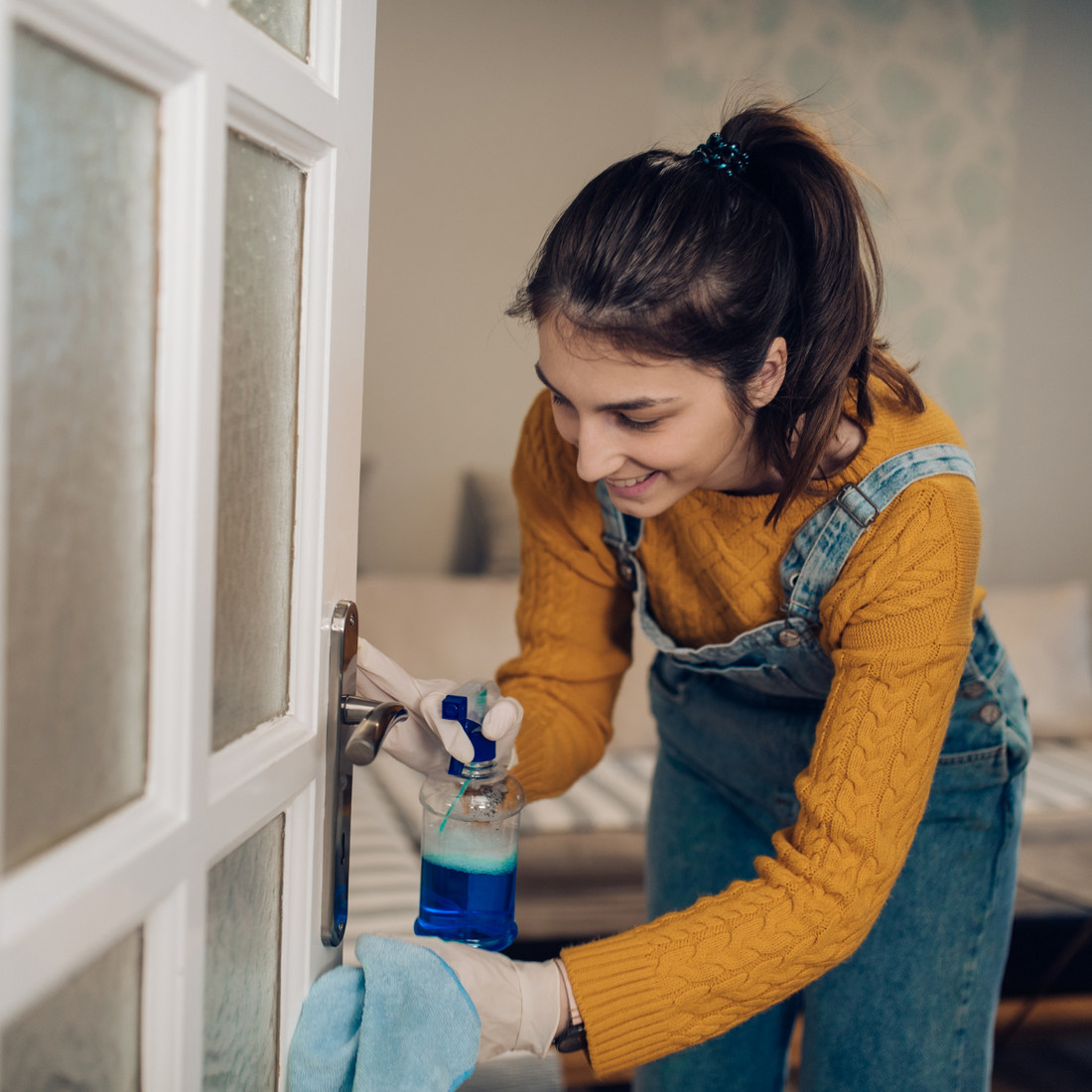 woman cleaning door knob